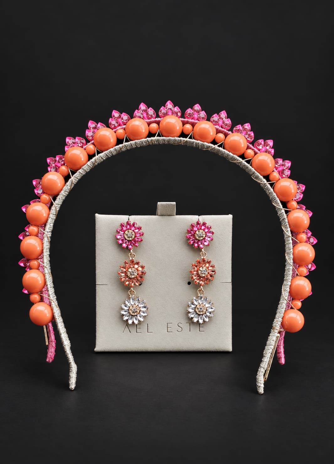 A gold beaded headband with orange beads and pink floral accents, displayed matching drop earrings flower earrings