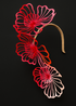 Decorative headband millinery with red and pink floral designs on a black background for melbourne cup 2025
