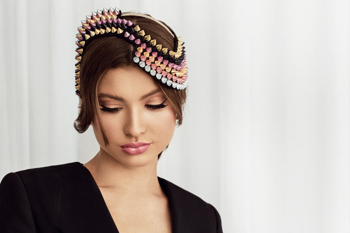 A woman wearing a Colourful headband for spring racing 2026
