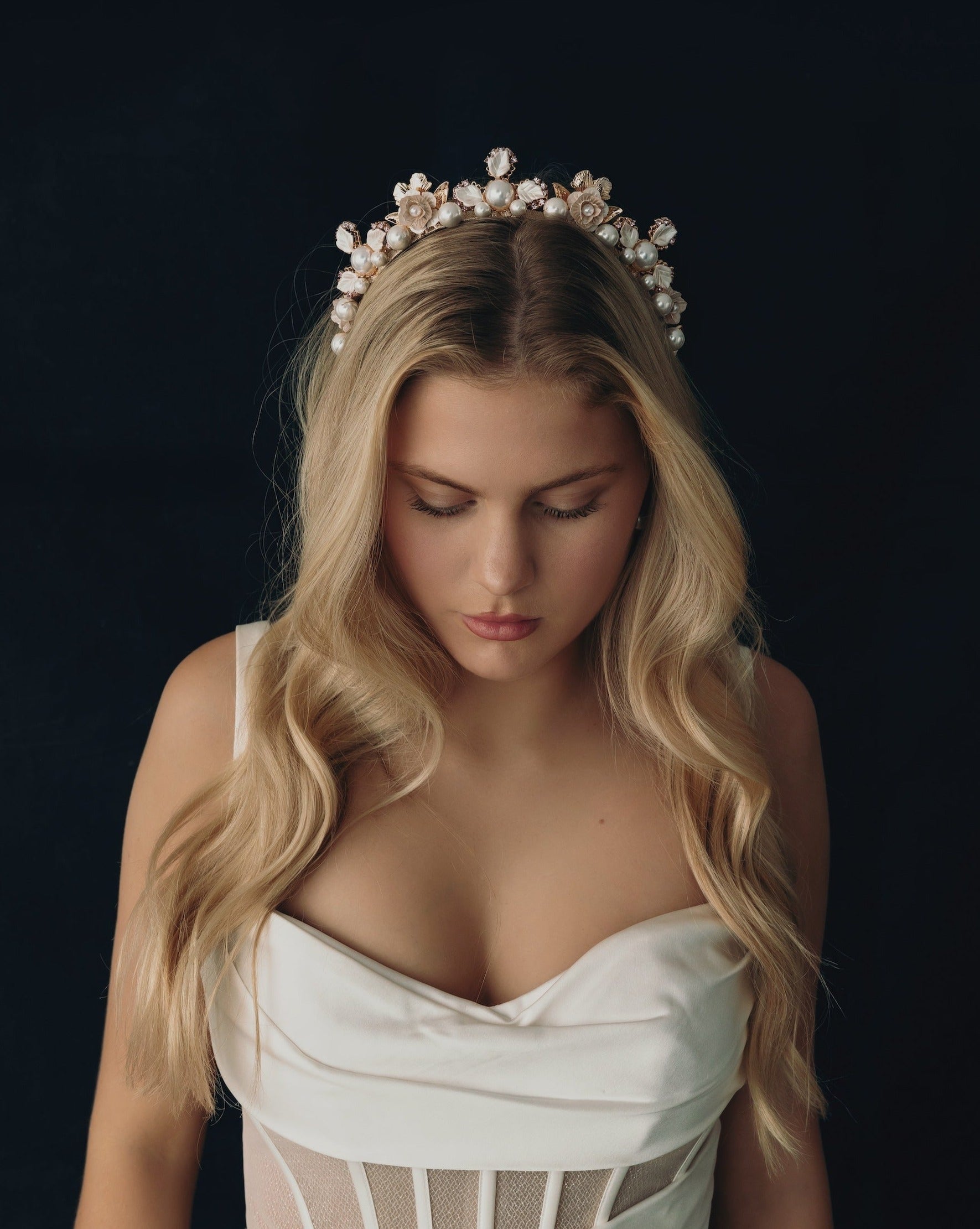 bride wearing a modern white floral wedding crown headband