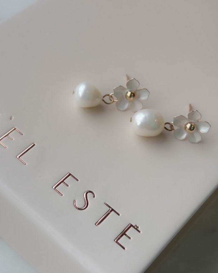 delicate bridal earrings with pearls and a little white flower on a nicely packaged bridal box